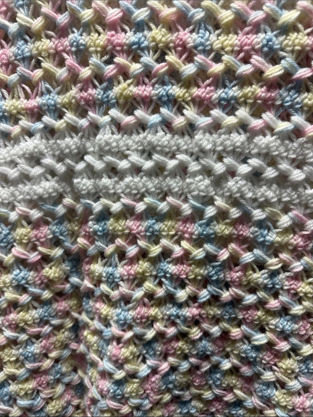 White Crochet Baby Throw with Pastel Pink, Blue, and Yellow Accents